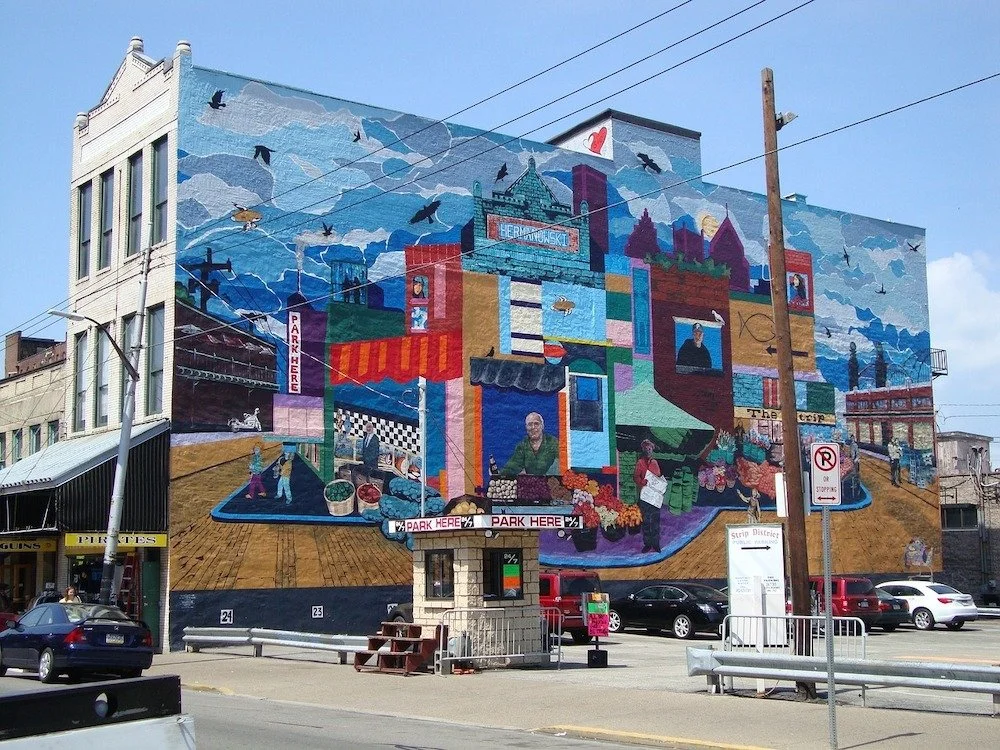 A colorful mural coats the side of a building in one of Pittsburgh's best neighborhood spots.